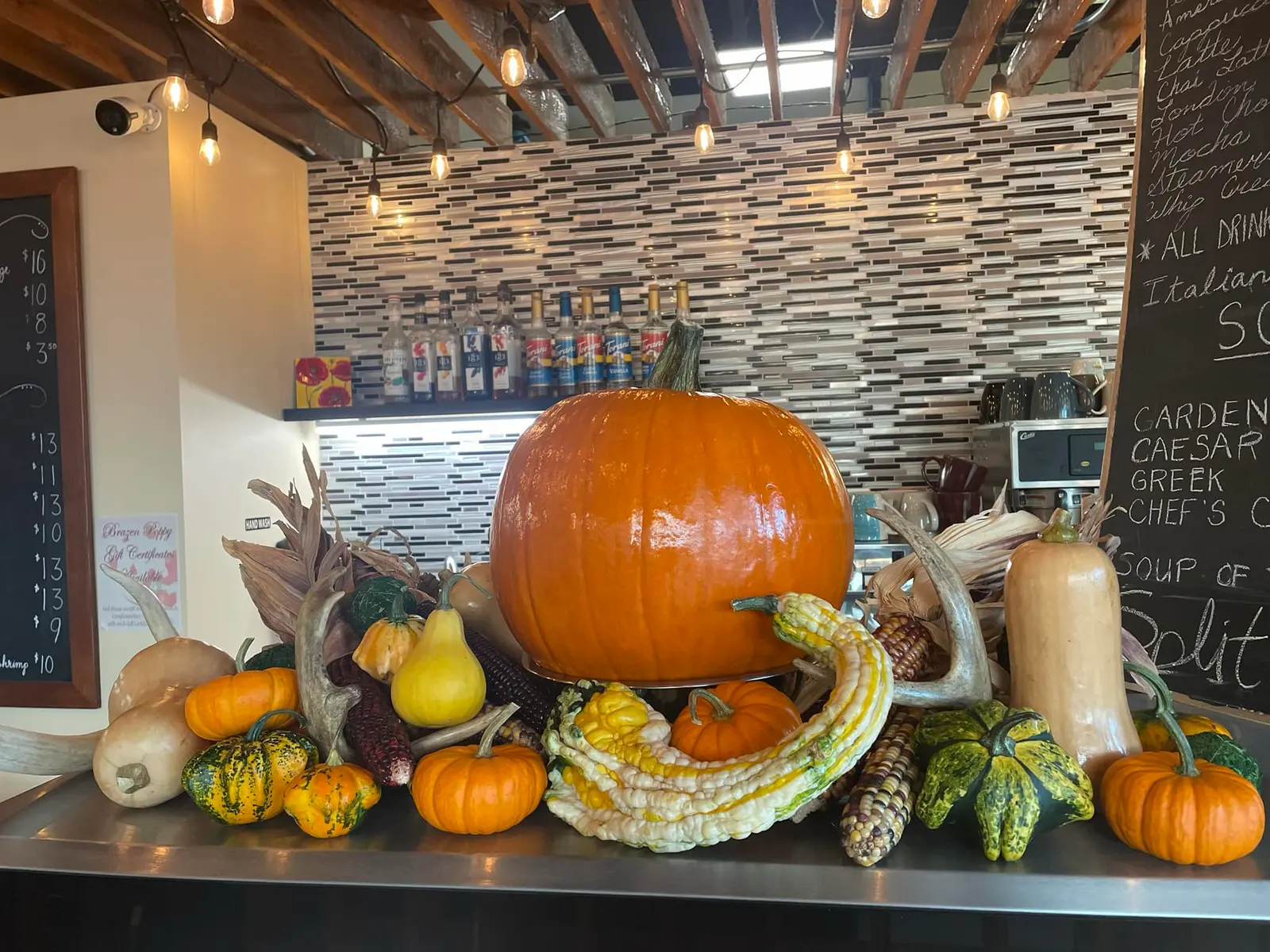 Inside the café: the coffee bar, chalkboard menu and a seasonal display